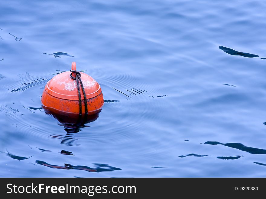 Buoy isolated on blue water