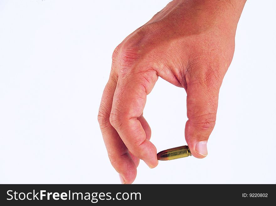 A man's hand holding a bullet
