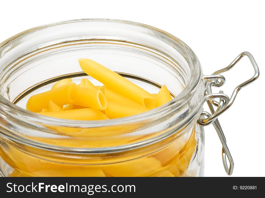 Pasta in glass can on a white background