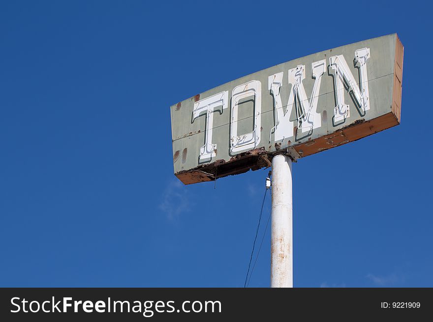 Vintage town sign with dark blue sky background. Vintage town sign with dark blue sky background.