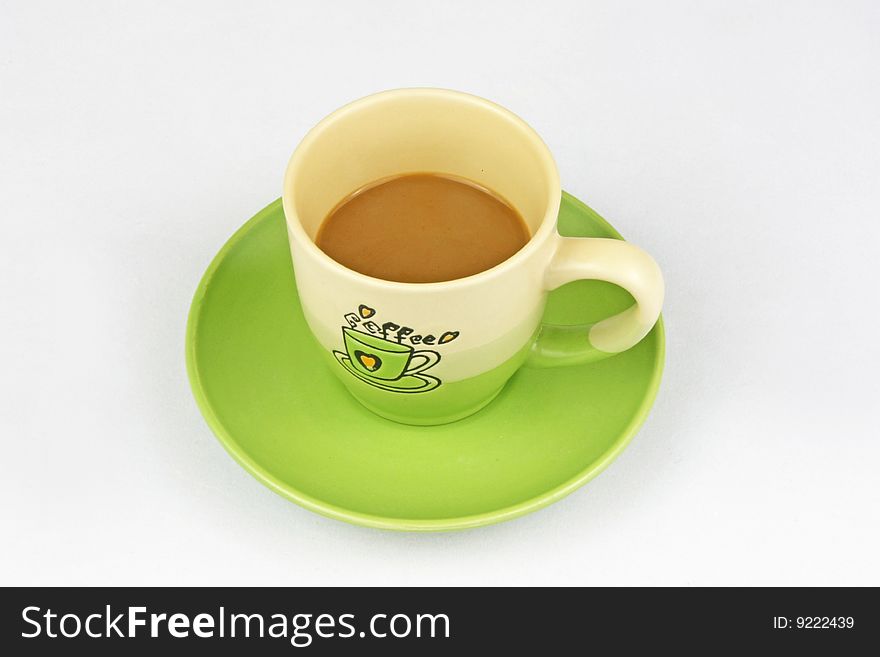 The green coffee cup is in white background