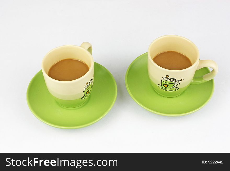 The green coffee cup is in white background