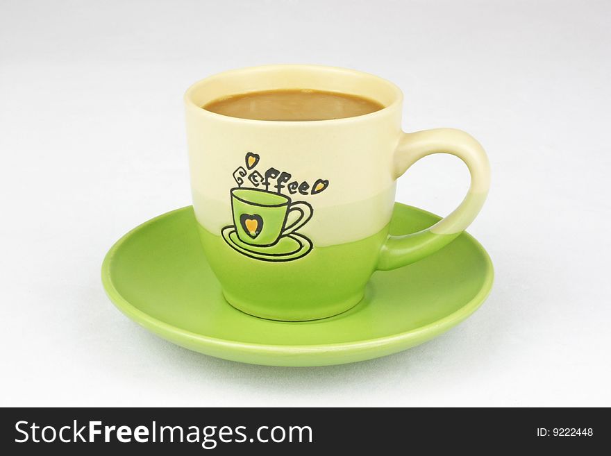 The green coffee cup is in white background