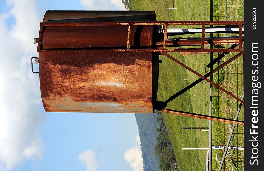 Rusted gas tank in landscape