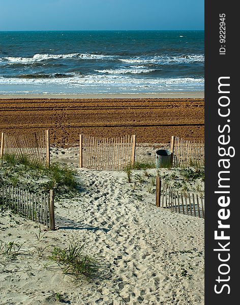 An exit to the sandy beach near the Atlantic ocean in the morning time