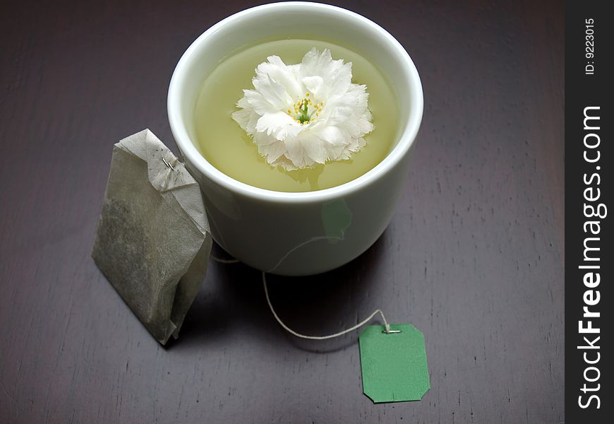 Floral tea on a dark brown table with flowers. Floral tea on a dark brown table with flowers