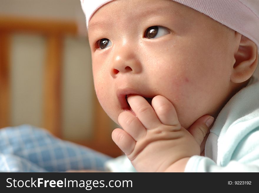 It is a cute chinese baby, eating his hand. he is 4 months. It is a cute chinese baby, eating his hand. he is 4 months.