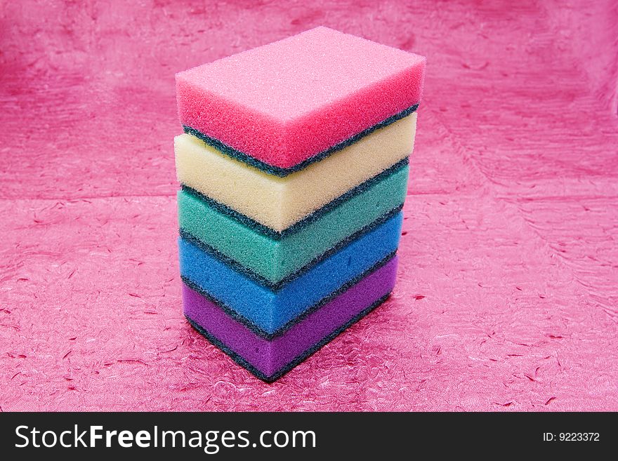 Making your house beautiful: cleaning sponges isolated on pink cloth
