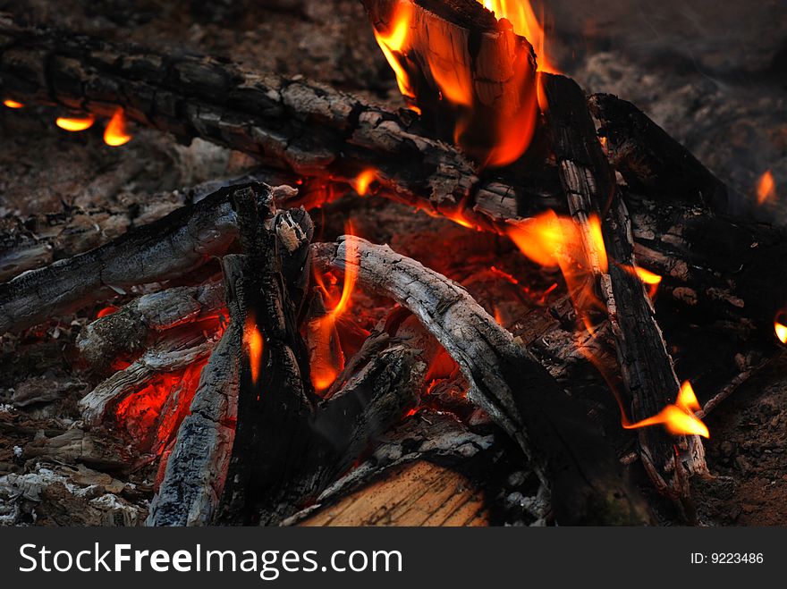 The embers, coals and flames of a campfire. The embers, coals and flames of a campfire.