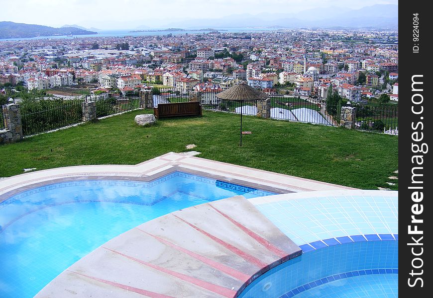 Circular jacuzzi overlooking Fethiye Bay in Turkey and the swimming pool below. Circular jacuzzi overlooking Fethiye Bay in Turkey and the swimming pool below.