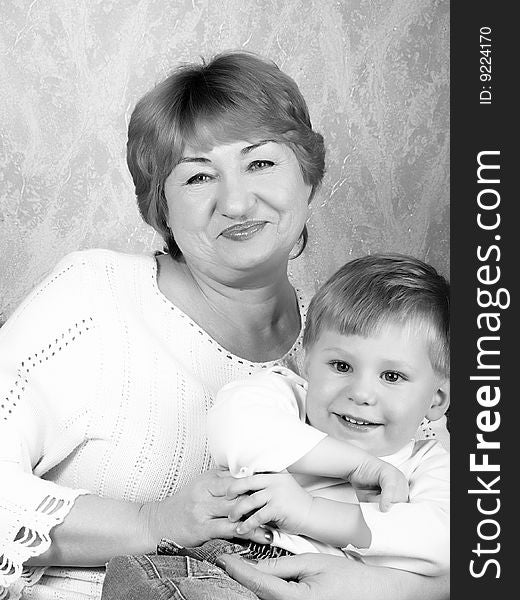 Portrait of the grandmother with the grandson in house conditions