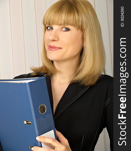 Folder for papers in hands at business of the woman in black clothes