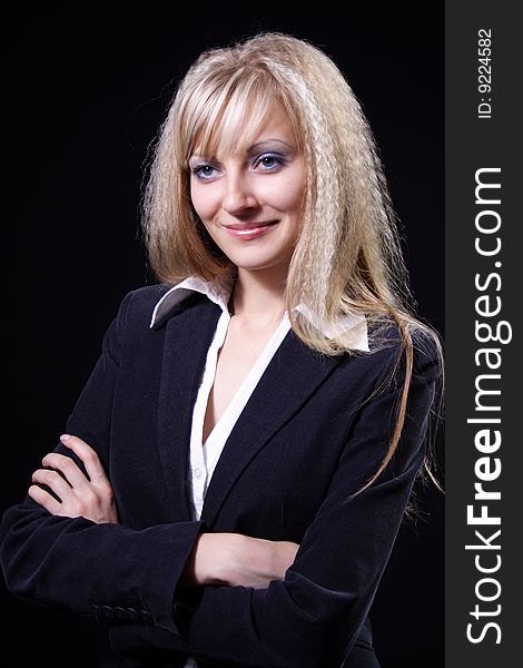 Nice girl in a business suit on a black background. Nice girl in a business suit on a black background