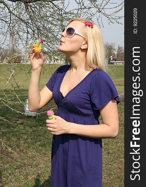 Girl blowing soap bubbles outdoor