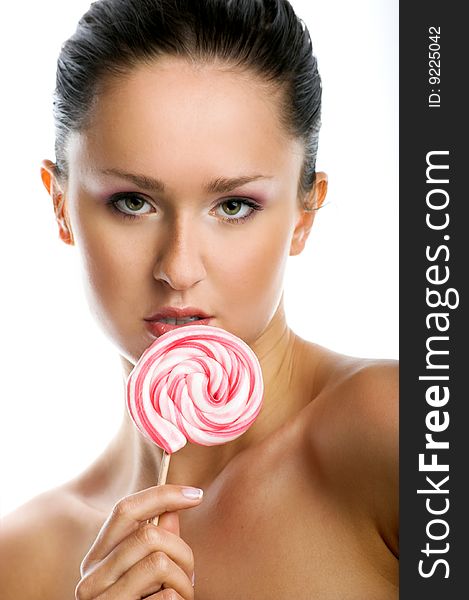 Beauty portrait of a young woman with a lollipop. Beauty portrait of a young woman with a lollipop