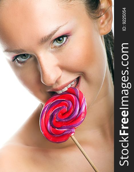 Beauty portrait of a young woman with a lollipop. Beauty portrait of a young woman with a lollipop