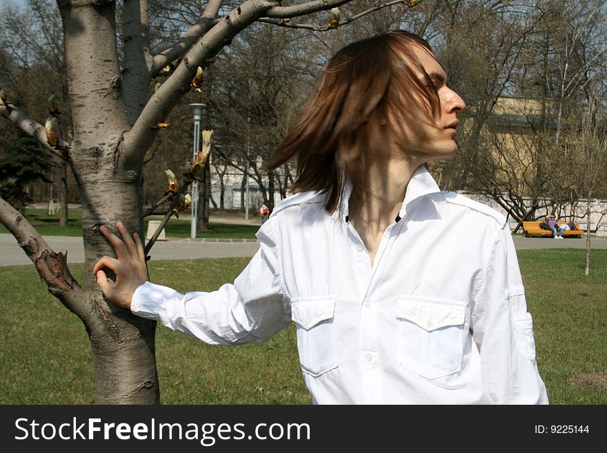 Man Standing Near A Tree