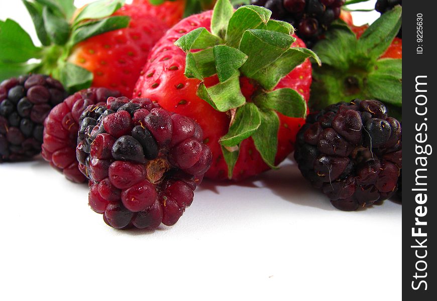 An arrangement of strawberries and blackberries on a white background. An arrangement of strawberries and blackberries on a white background