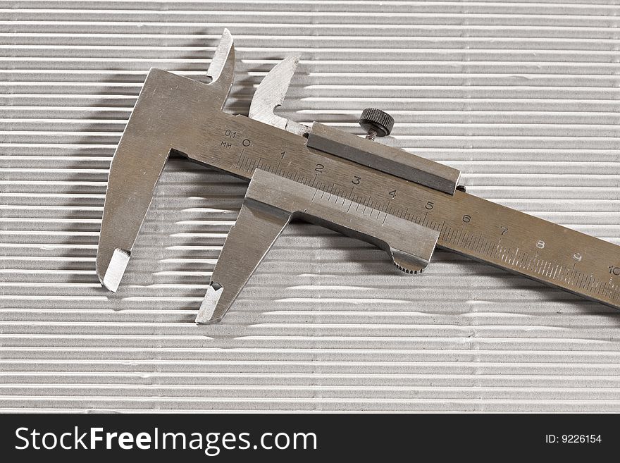 Tools series: metal trammel on ribbed surface