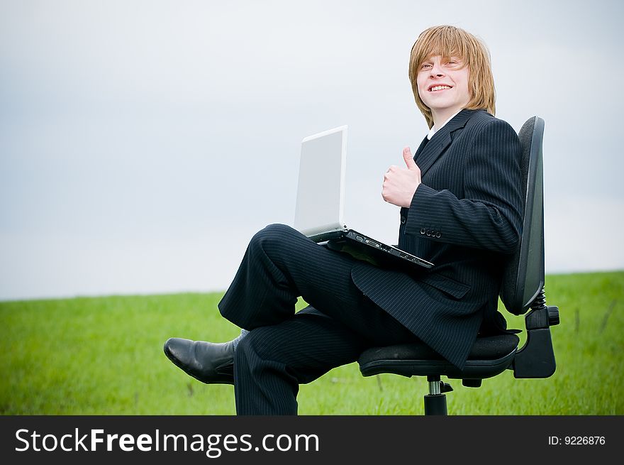 Smiling Young Businessman With Laptop