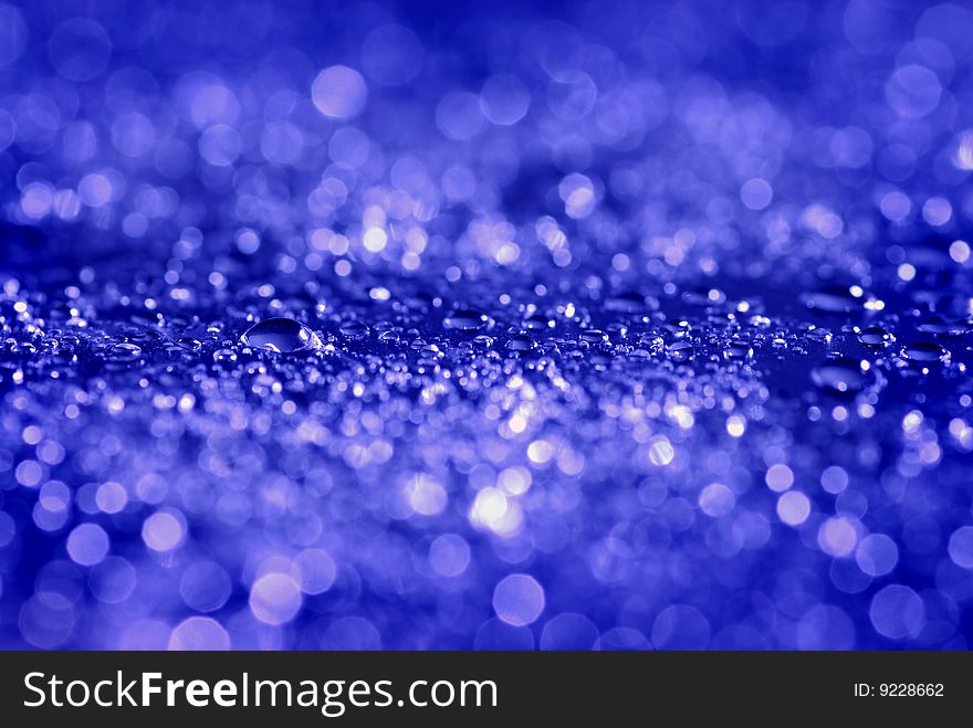 Closeup of fresh clean water drops on blue background