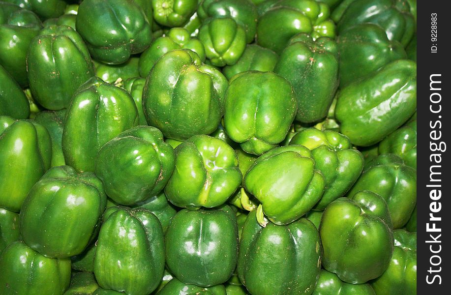 Green background texture, group of green paprika bell peppers in market