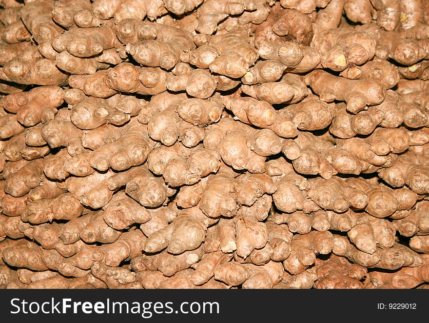 Background of dry ginger roots on the floor in India