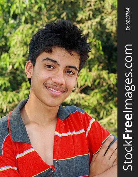 A handsome young Indian teenager in a relaxed and easy mood. A handsome young Indian teenager in a relaxed and easy mood.