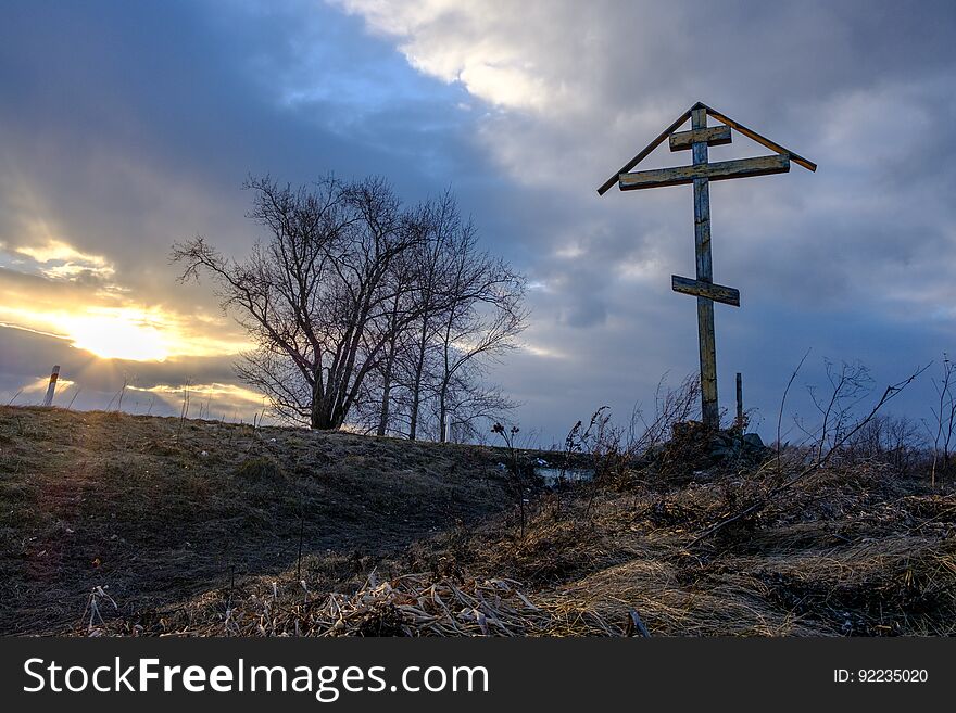 A wooden cross near the village protects from evil spirits. A wooden cross near the village protects from evil spirits
