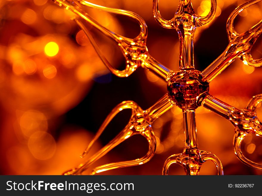 Close up of glass ornament with orange light background. Close up of glass ornament with orange light background.