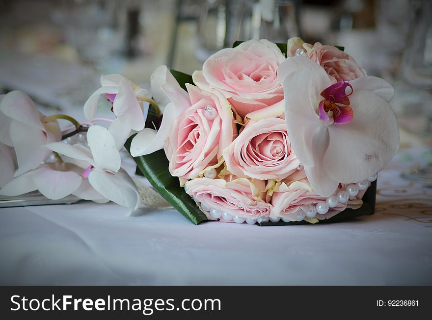 Close up of bridal bouquet with pink roses and orchids.