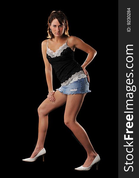 Young woman fashion model posing against a black background