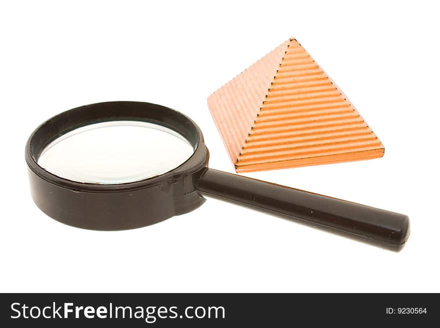 Figure of a yellow pyramid with a magnifier laying nearby. Figure of a yellow pyramid with a magnifier laying nearby