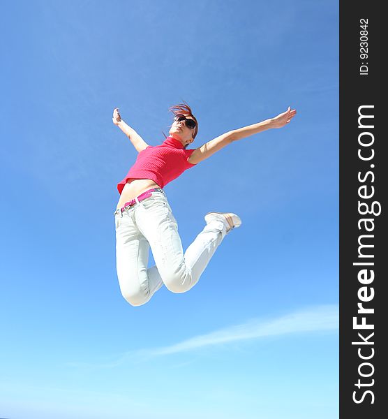 Happy jumping girl against blue sky. Happy jumping girl against blue sky