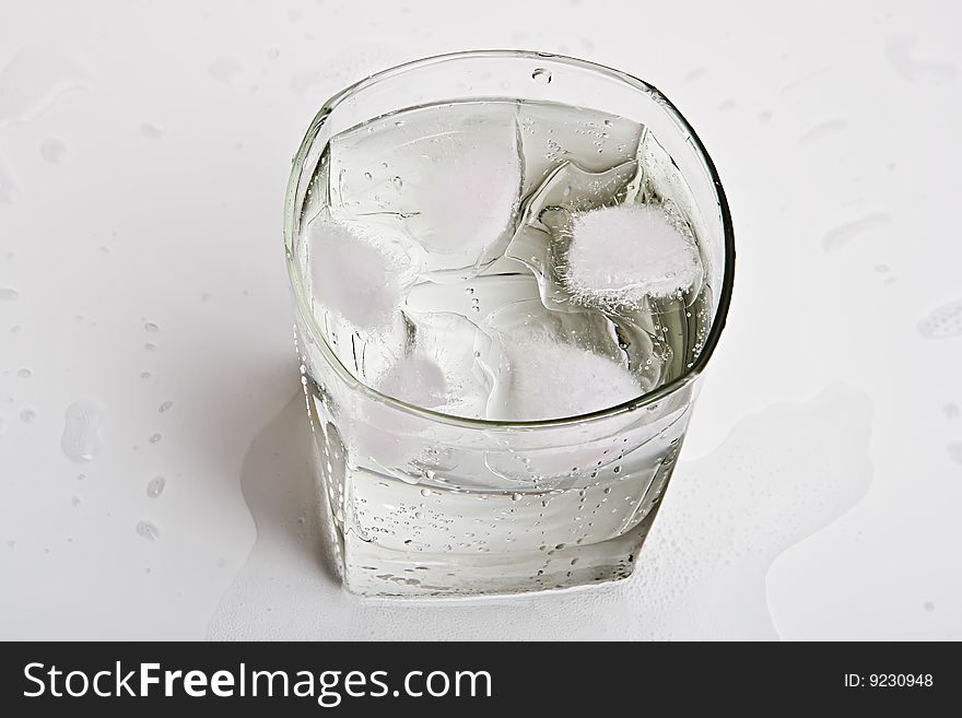 Glass with water and ice slices. Glass with water and ice slices