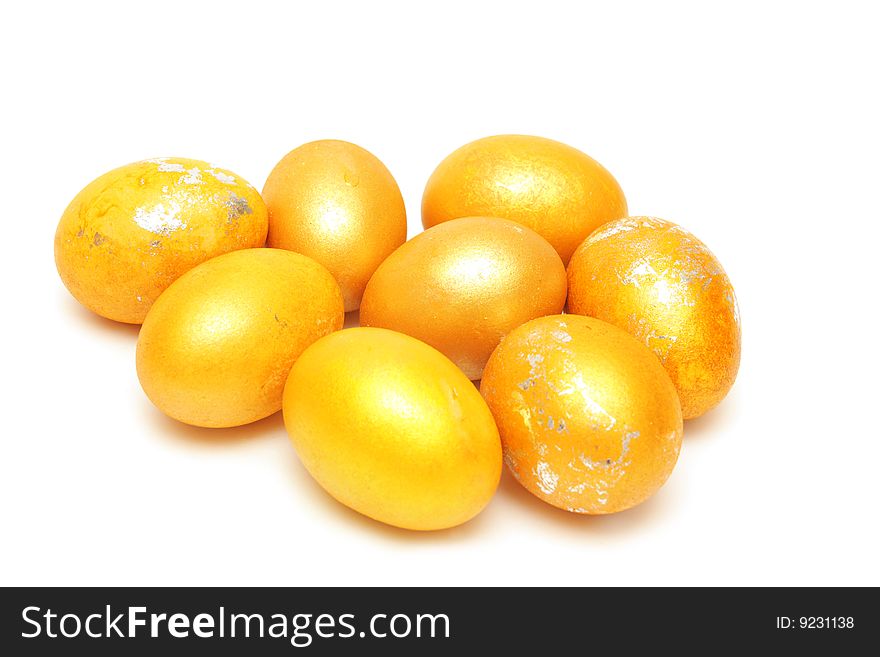 Golden eggs on white background