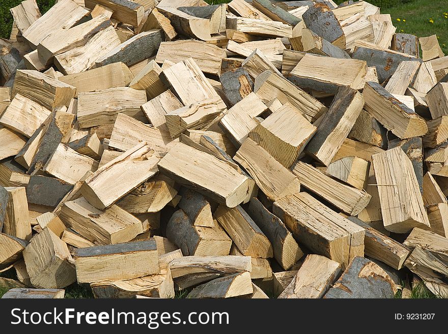 Chopped wood in a woodpile, ready for the wood burning stove