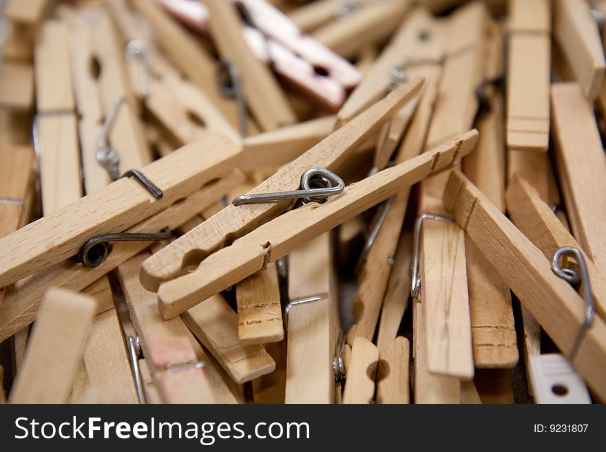 A group of clothespins on a table with shallow depth of filed.