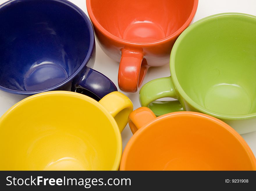 Multicolor cups on a white background