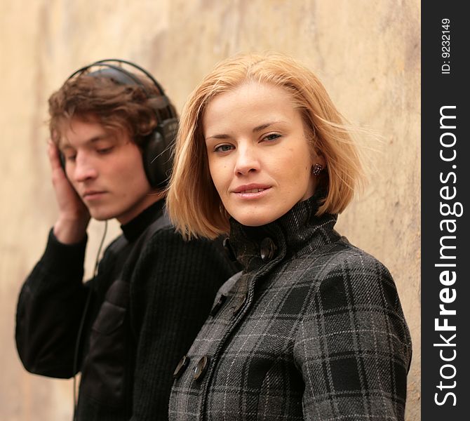 Blonde woman and man is listening to music on the front burner. Blonde woman and man is listening to music on the front burner