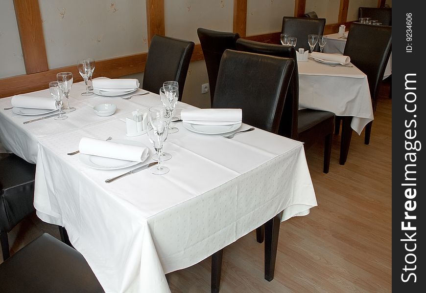 Table with cutlery, plaits and glasses in Restaurant. Table with cutlery, plaits and glasses in Restaurant