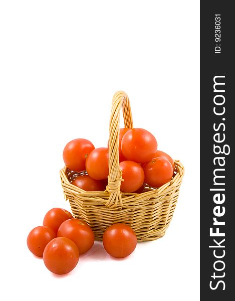 Cherry berr ytomatoes in a wicket isolated on white background