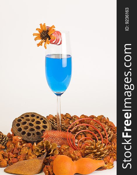 Cocktails blue and composition of dried flowers on a white background. Cocktails blue and composition of dried flowers on a white background