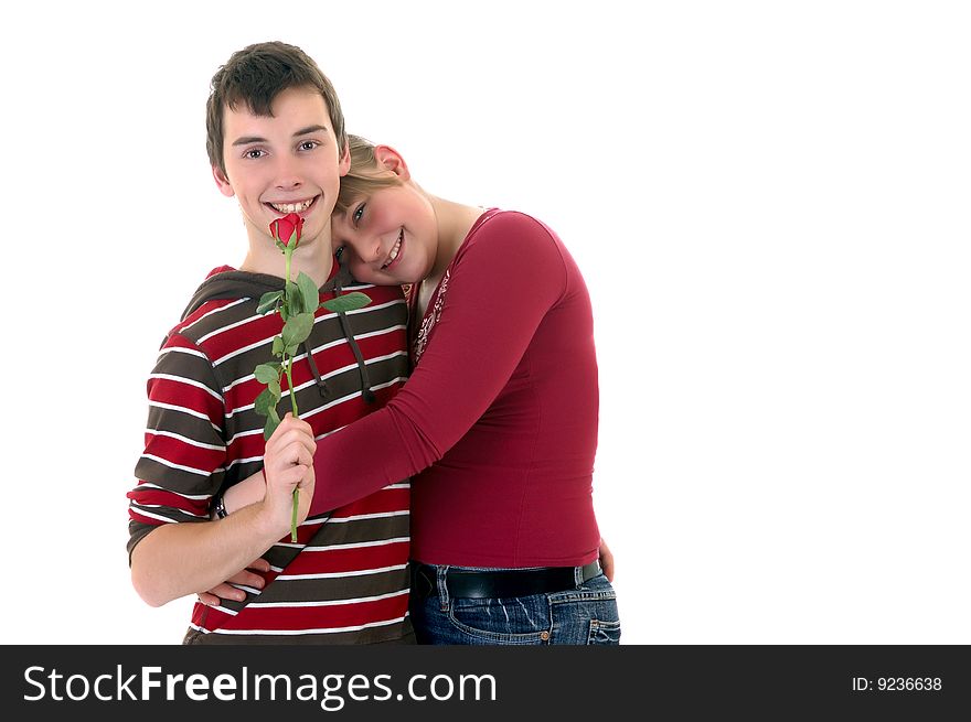 Two casual dressed teenagers , teenage man holding rose flower and woman in love. studio shot. Two casual dressed teenagers , teenage man holding rose flower and woman in love. studio shot.