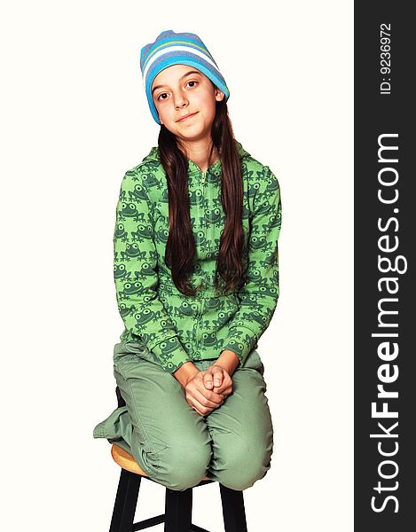 Girl dressed all in green with long brown hair and blue cap kneeling
on a bar chair for white background. Girl dressed all in green with long brown hair and blue cap kneeling
on a bar chair for white background.