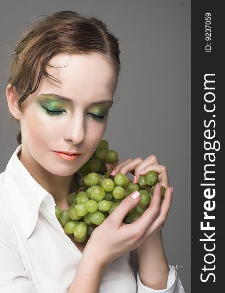 Portrait of young woman with green grapes. Portrait of young woman with green grapes