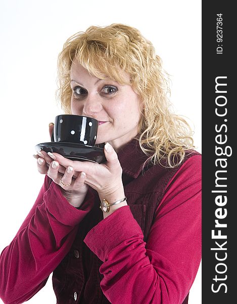 A beautiful woman is drinking coffee out of mugs in black. A beautiful woman is drinking coffee out of mugs in black