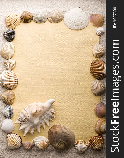 A beautiful yellow letter with shells on sand. A beautiful yellow letter with shells on sand