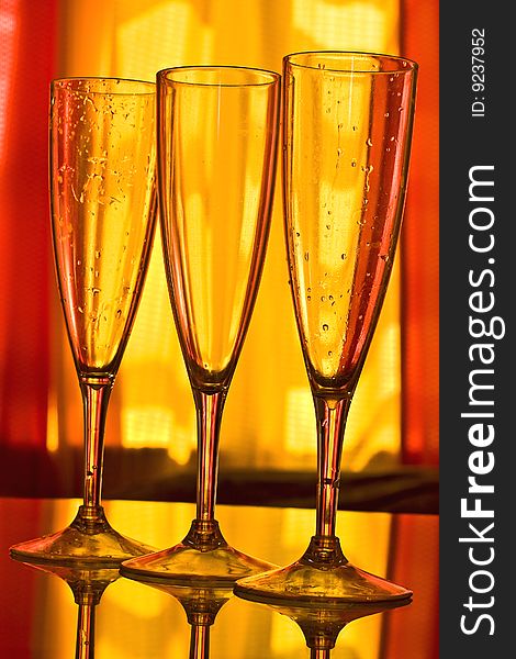 Champagne glass with yellow and orange background. Champagne glass with yellow and orange background