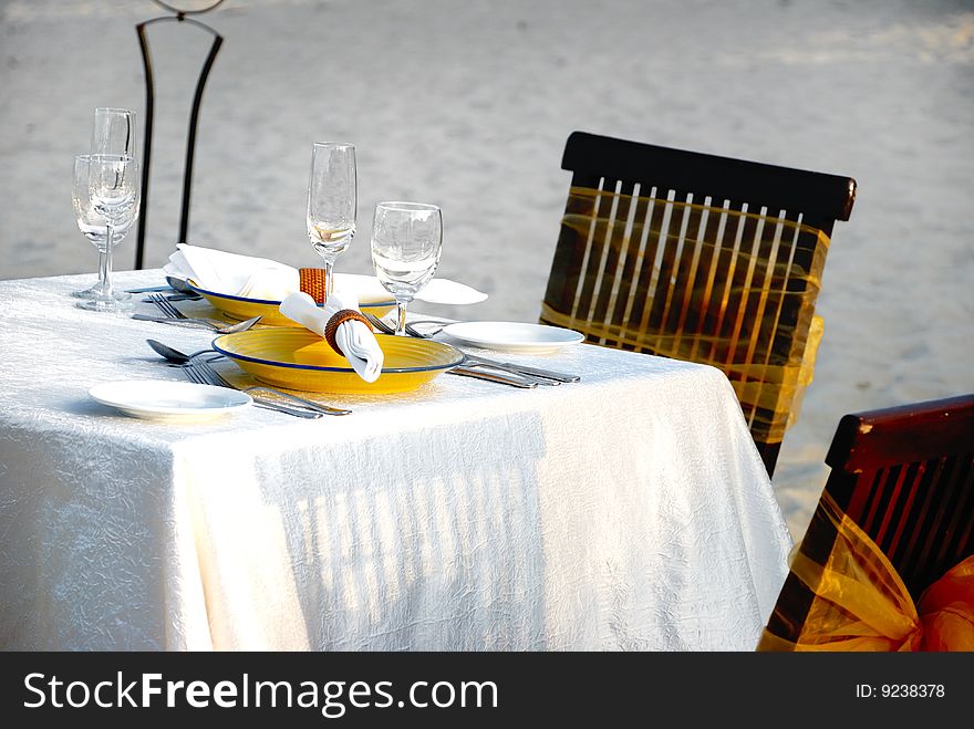 Isolated Dining table on white beach sand. Isolated Dining table on white beach sand